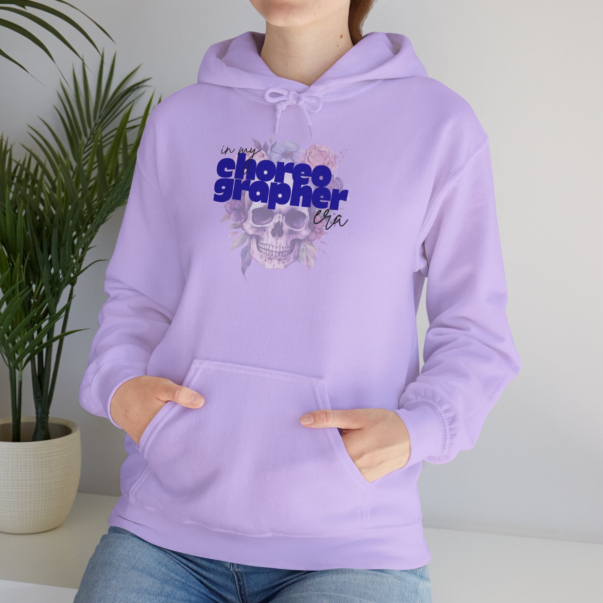 Person wearing a lavender hoodie with 'choreographer' text and skull design.