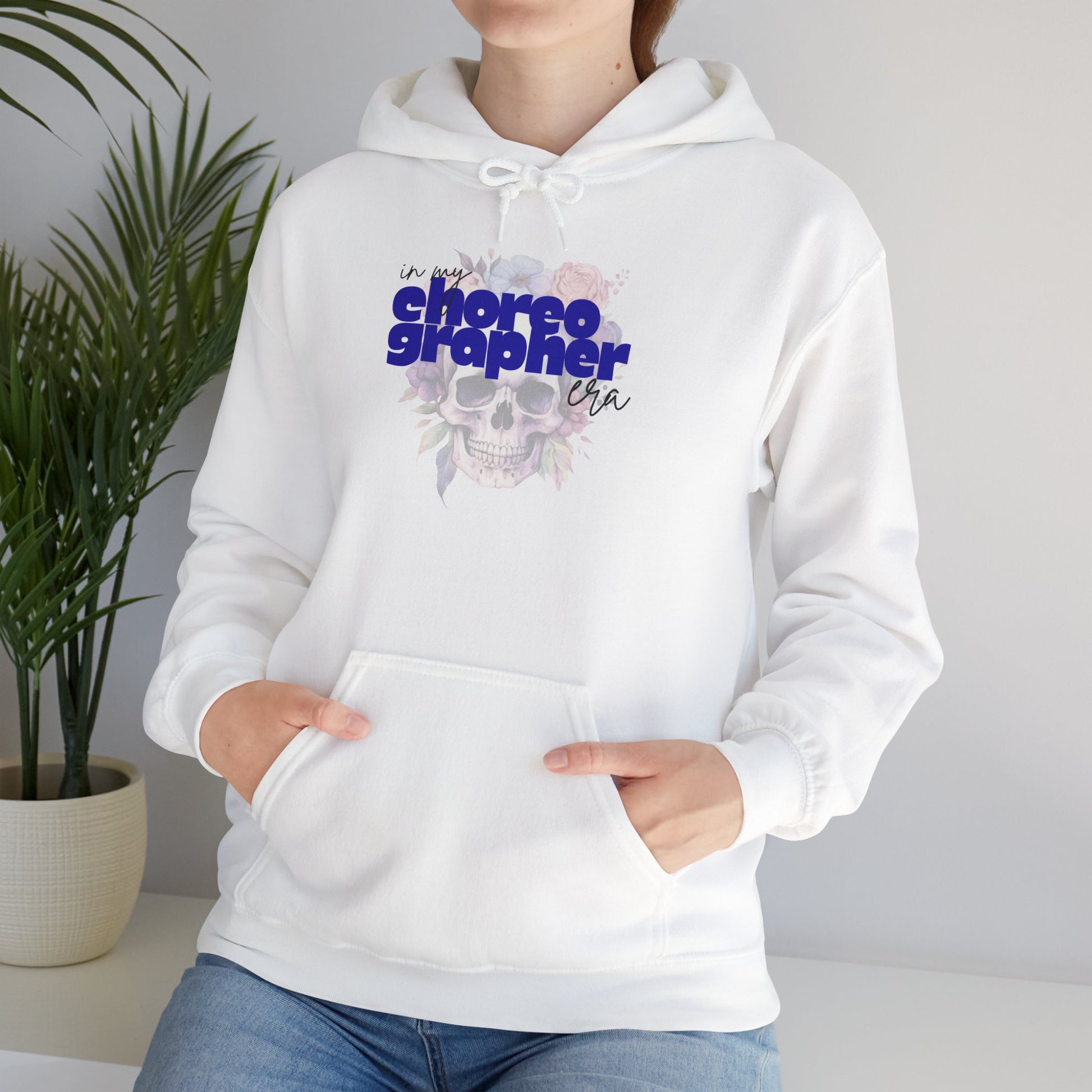 White hoodie with 'I'm the choreographer' text and floral design on a plain background