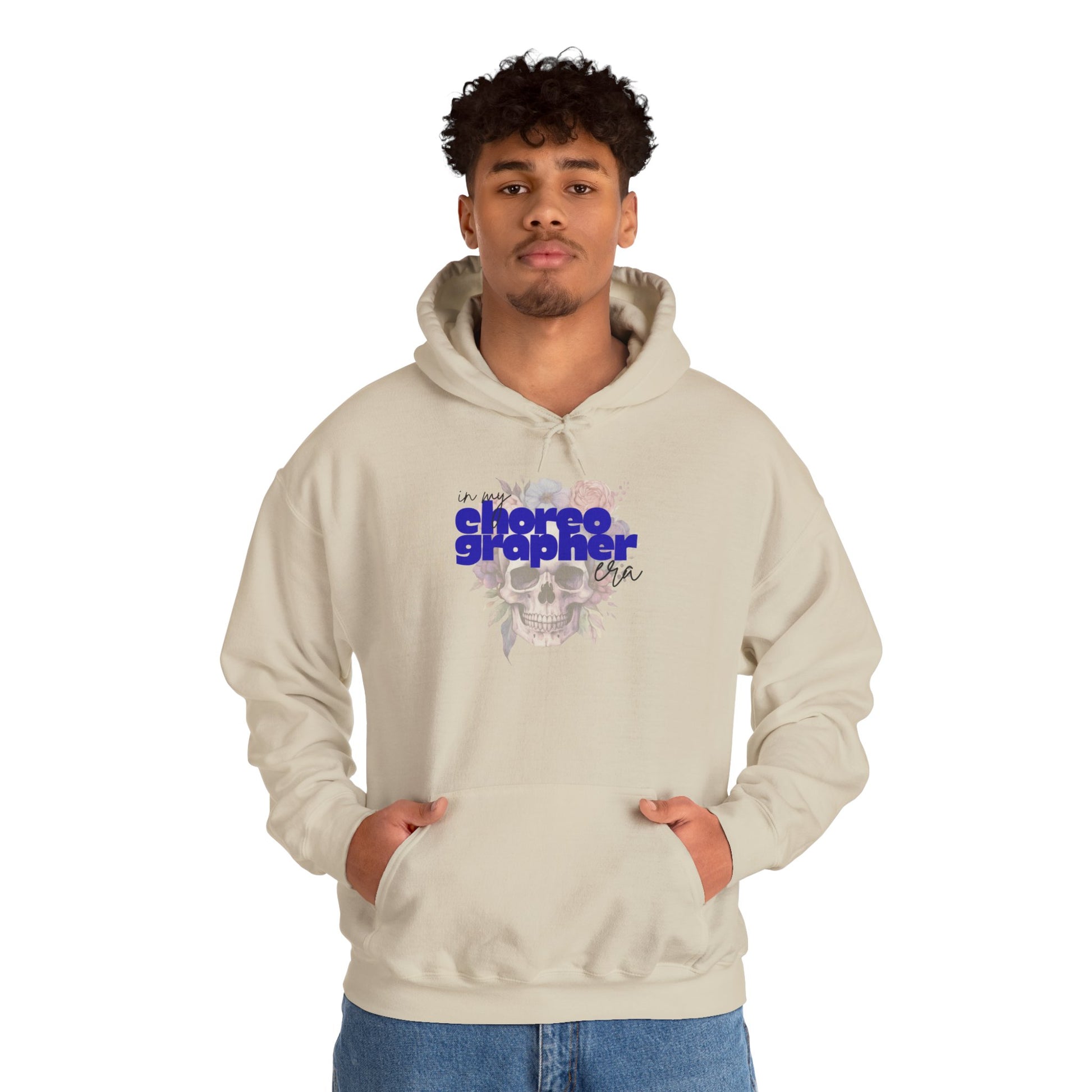 Person wearing a beige hoodie with text and graphics on a white background