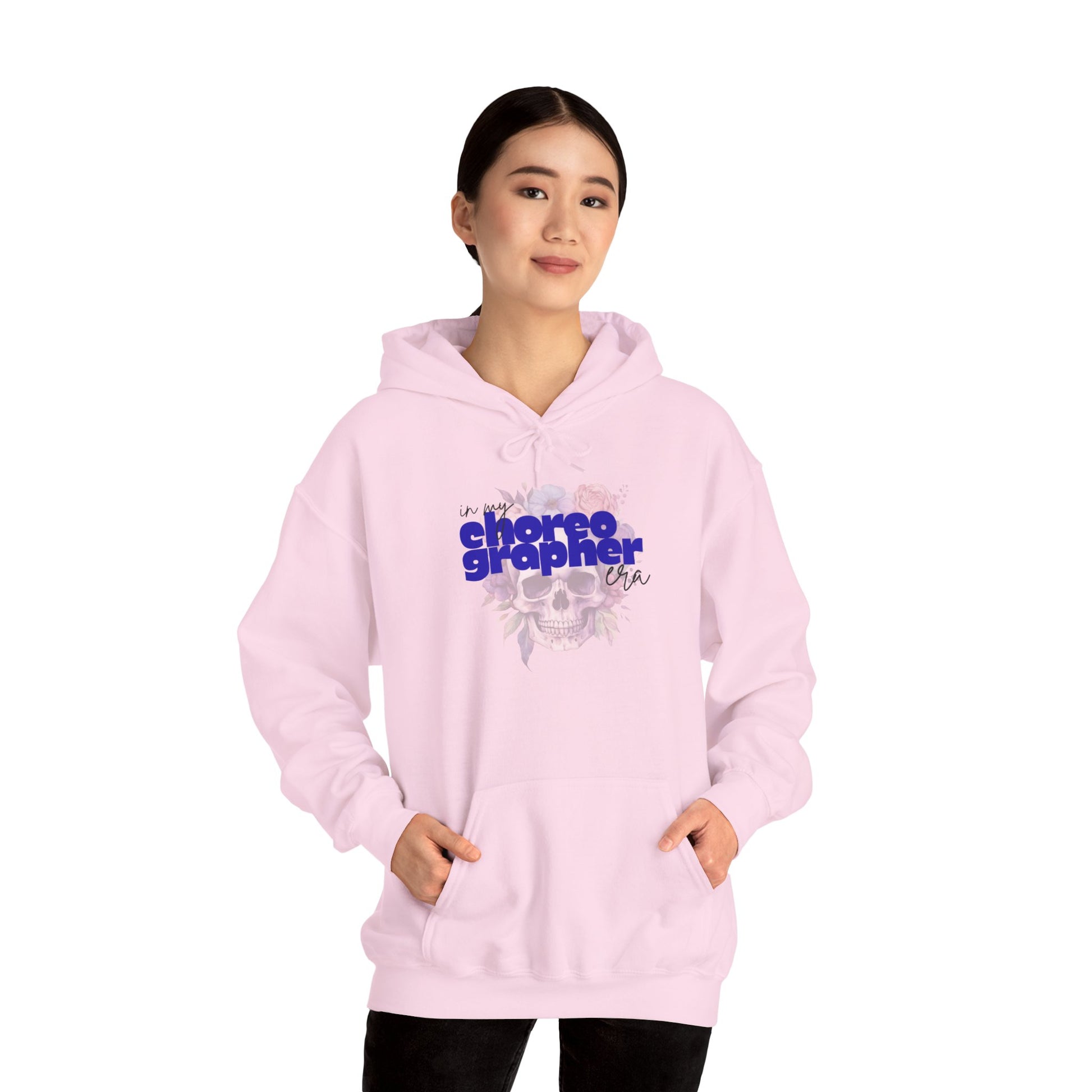 Person wearing a pink hoodie with 'choreographer' text on a white background
