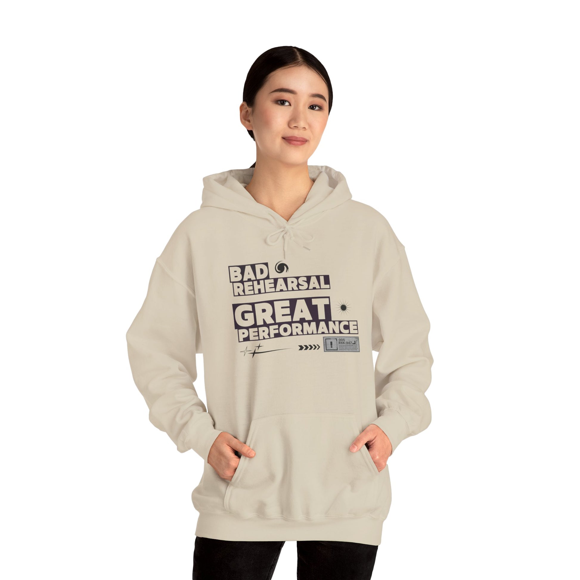 Person wearing a beige hoodie with text design on a white background