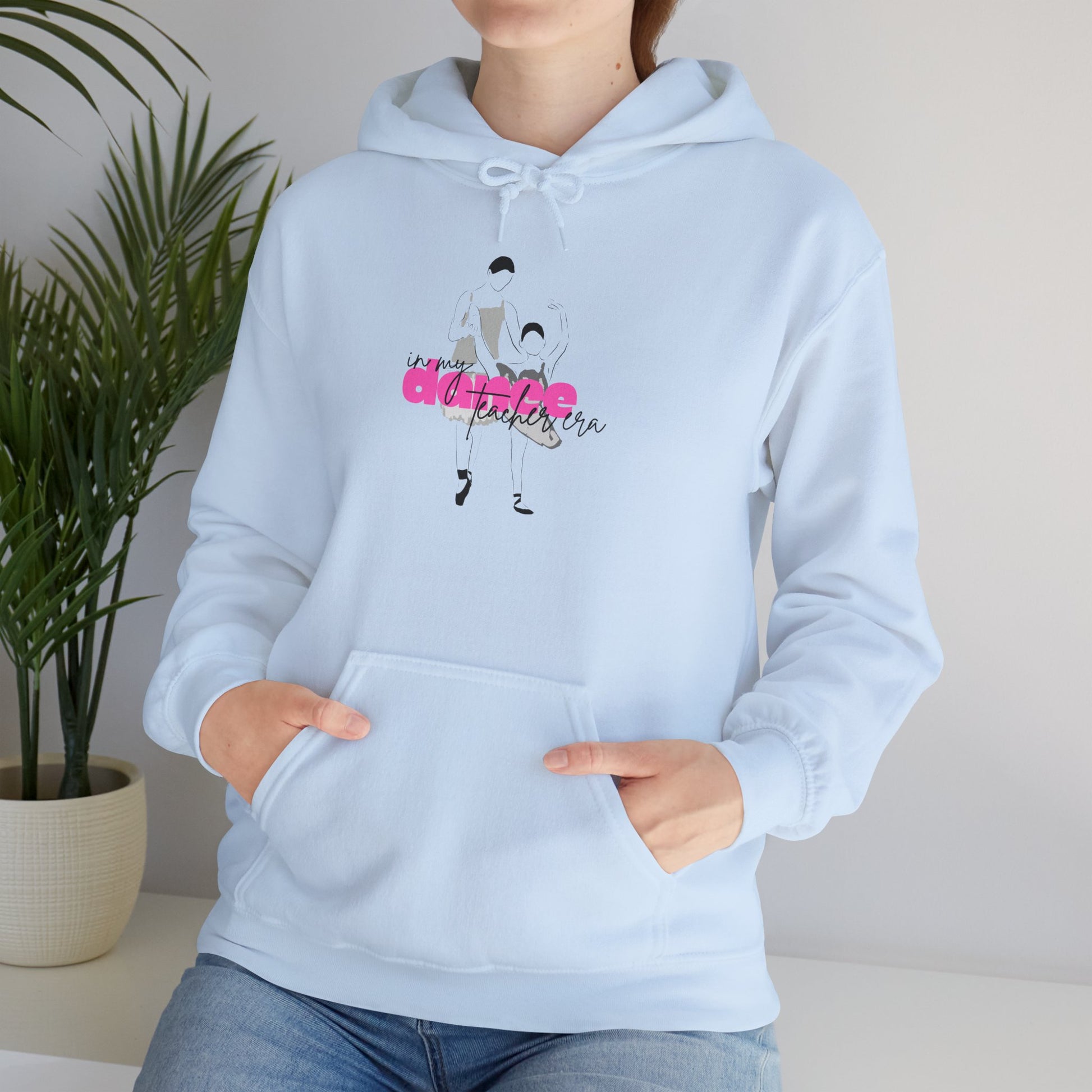Light blue hoodie with a graphic design and text, worn by a person, against a neutral background.