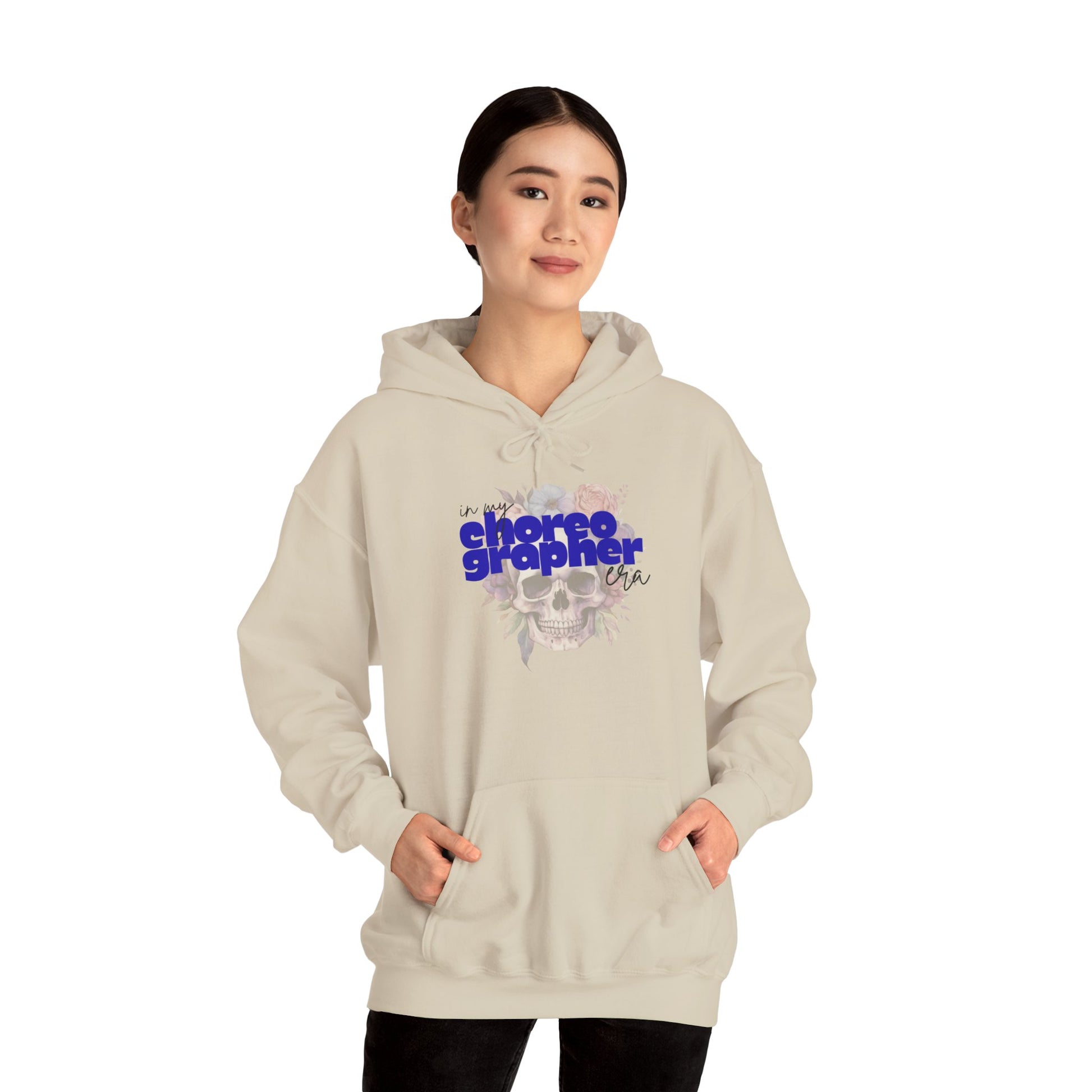 Person wearing a beige hoodie with text design on a white background