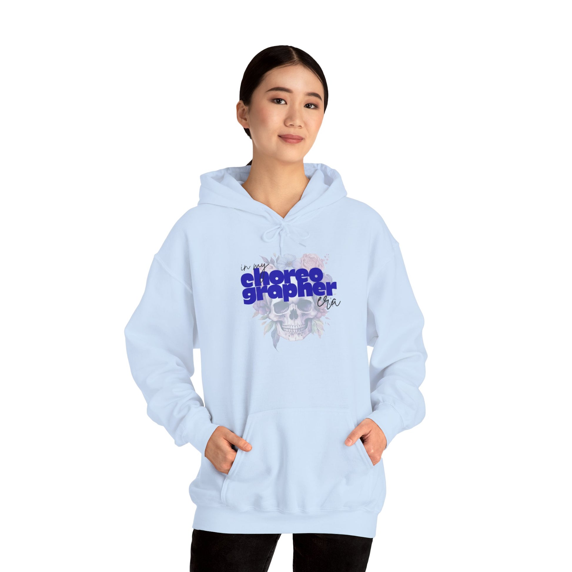 Light blue hoodie with 'choreographer' text worn by a person on a white background