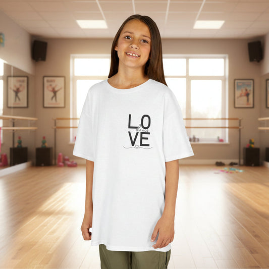Young girl wearing a white t-shirt with 'LOVE' printed on it in a dance studio