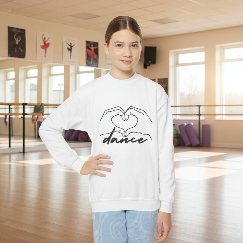 Person wearing a white sweatshirt with 'dance' design in a dance studio